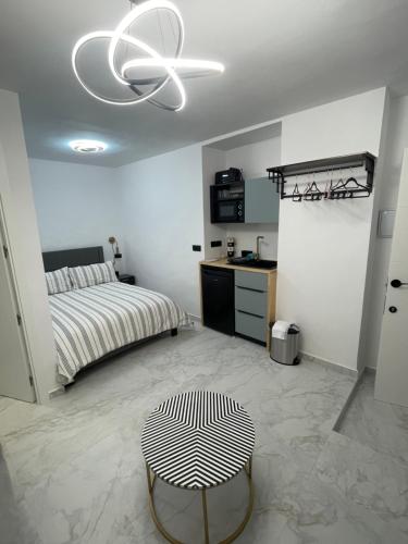 a bedroom with a bed and a white ceiling at Petit Castillo in Almansa