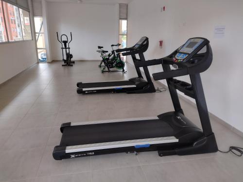 a gym with two exercise bikes and a treadmill at Apartamento Amoblado Alameda del Rio Barranquilla in Barranquilla