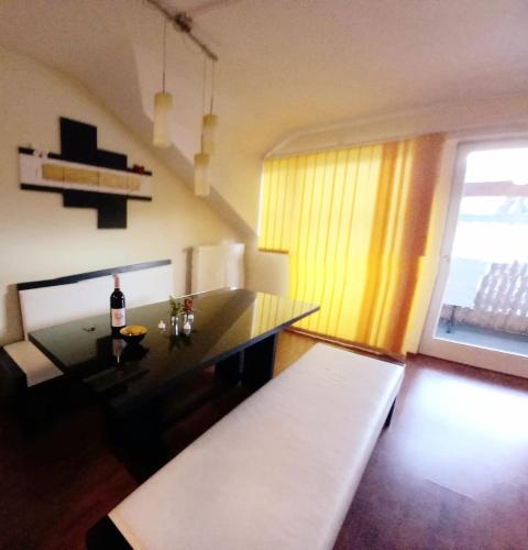 a living room with a table and a bottle of wine at Haus Branol in Hermagor