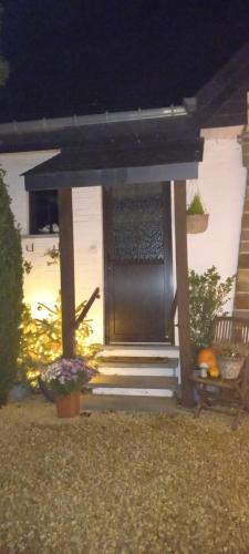 a front door of a house at night at Côté Cosy in Marche-en-Famenne