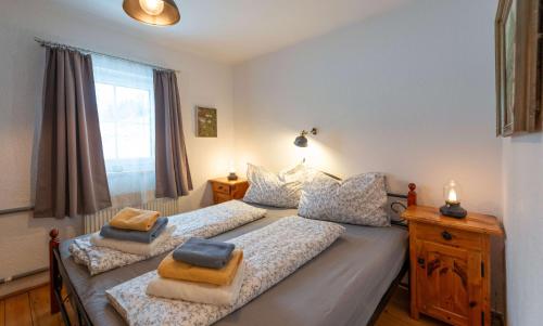 a bedroom with two beds and a window at Ferienwohnung Haus Sonnenschein - Your Austrian Home in Grundlsee