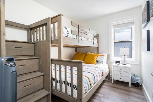 a bedroom with a wooden bunk bed with yellow pillows at "Ski" at Hills Meaford, Second Floor Suite w Bunk Beds in Meaford