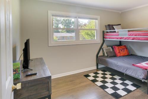 a bedroom with a bunk bed with a desk and a window at Family-Friendly Blacksburg Retreat with Playground! in Blacksburg