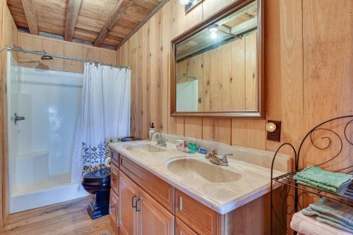 a bathroom with a sink and a mirror and a shower at Pet-Friendly Opp Vacation Rental with Spacious Deck! in Opp