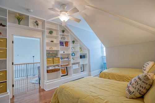 a bedroom with two beds and a ceiling fan at Habersham Retreat on Abbey Row in Beaufort