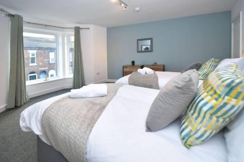 a bedroom with two beds and a window at Lyndale Lofts - By Sigma Stays in Crewe