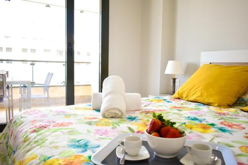 a bedroom with a bed with a bowl of fruit on it at Los Alamos Beach - Parking in Torremolinos