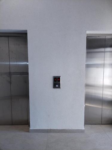 a wall with two elevators in a building at S&B Apartman Vrnjačka Banja in Vrnjačka Banja