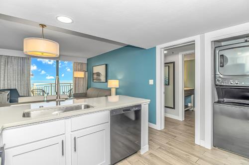 a kitchen with a sink and a dishwasher at Stunning Oceanfront 2 Bedroom Suite- Sailfish Resort 1111 in Myrtle Beach