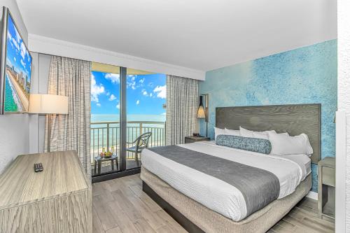 a bedroom with a bed and a view of the ocean at Stunning Oceanfront 2 Bedroom Suite- Sailfish Resort 1111 in Myrtle Beach