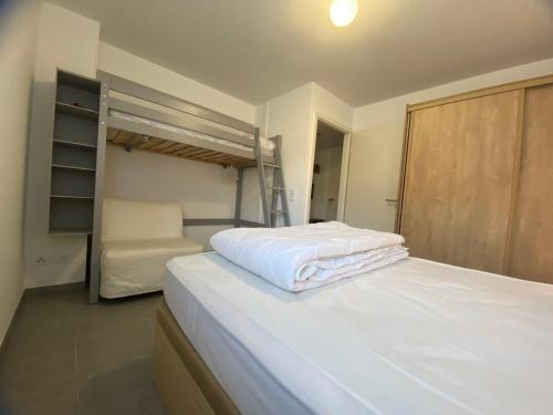 a bedroom with a bed and a bunk bed at Appartement lumineux avec terrasse & Wifi à Verchaix - FR-1-642-82 in Verchaix