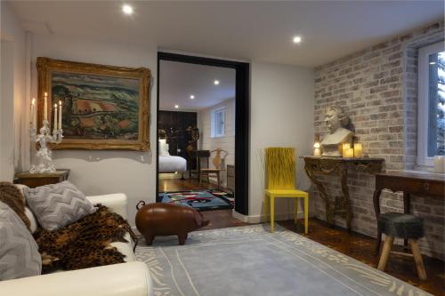 a living room with a couch and a brick wall at Snow Lodge Hotel Courchevel 1850 in Courchevel