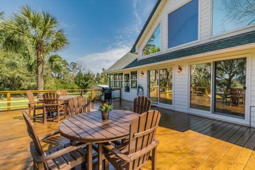 a patio with a table and chairs on a deck at Private Retreat on Deep Water overlooking Jenkins Creek in St. Helena Island