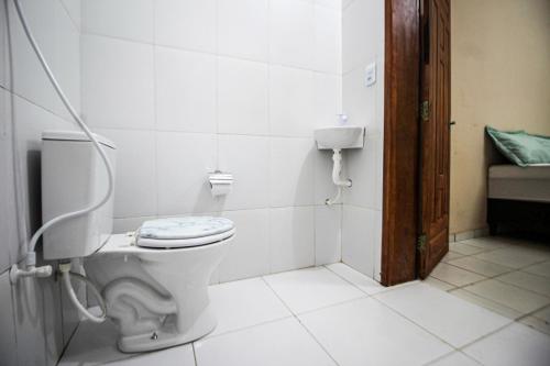a bathroom with a toilet in a room at Hotel e Hostel da Fonte in São Luís