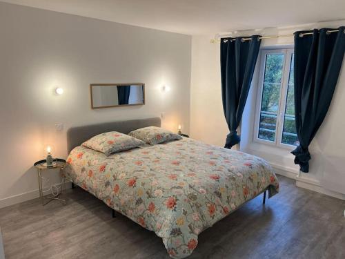 a bedroom with a large bed and a window at La Mezzavilla in Nuits-Saint-Georges