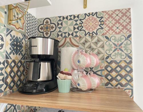 a kitchen counter with a coffee maker and a cupcake at Hestia Lux in Cluj-Napoca
