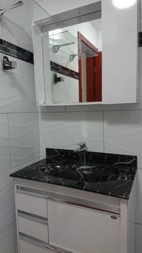 a kitchen counter with a sink and a mirror at FLAT O POINT do CARNAVAL do FAROL da BARRA in Salvador