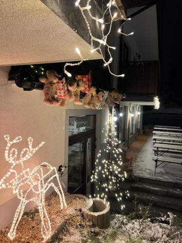 a christmas tree and a reindeer and christmas lights at Hotel Nosal Ski & Wine in Zakopane