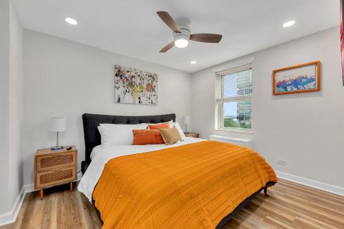 a bedroom with a bed and a ceiling fan at Downtown Condo Walk To Mercedes Benz Stadium in Atlanta