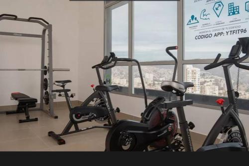 a gym with several exercise bikes in front of a window at Valpo y su encanto, a pasos de Viña y la costa in Viña del Mar