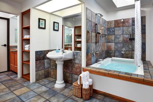 a bathroom with a tub and a sink at Seaport Village Inn, Avalon in Avalon