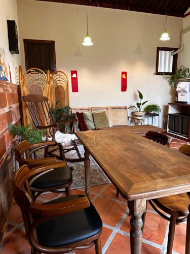 a dining room with a wooden table and chairs at Yamaharuka in Jinhu