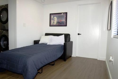 a bedroom with a bed with a blue blanket at Casa De Miller in Tamiami