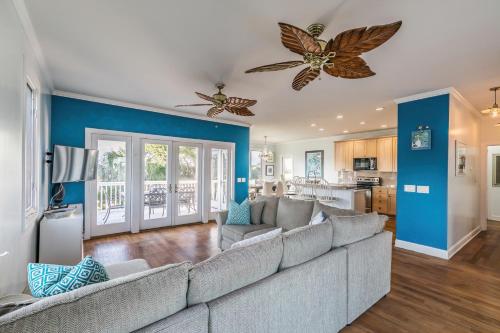 a living room with a gray couch and blue walls at Beach Access - Golf Cart Included - Views of the Marsh and Harbor River - Sleeps 10 in Harbor Island