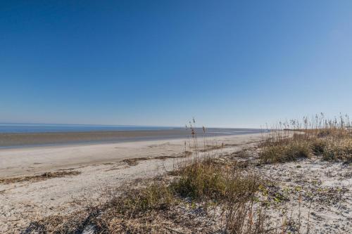 a sandy beach with the ocean in the background at Beach Access - Golf Cart Included - Views of the Marsh and Harbor River - Sleeps 10 in Harbor Island
