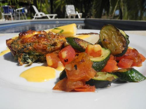 a plate of food with vegetables on a table at Casas Pelicano in Playa Junquillal
