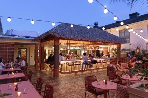 a restaurant with a bar and people sitting at tables at The Ryder Hotel in Charleston