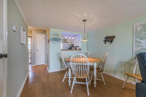 a dining room and kitchen with a table and chairs at NEW LISTING! Two Bedrooms in A Building with Marsh and Ocean Views in Harbor Island