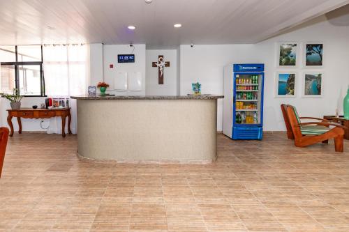 a large room with a counter and a refrigerator at Moriah Maceió Beach Hotel in Maceió