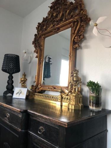 an ornate mirror on top of a dresser at Schönste Location in Würzburg in Würzburg