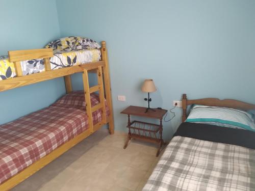 a bedroom with two bunk beds and a table at Km 9 in Viedma
