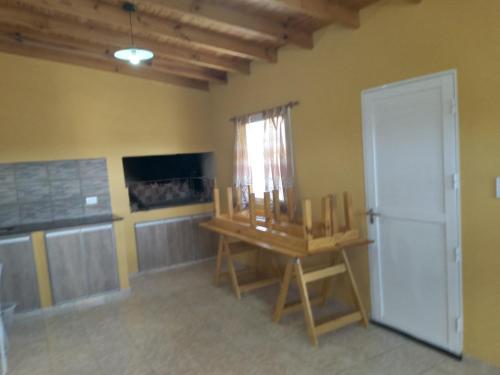 a room with a table and a refrigerator and a window at Km 9 in Viedma