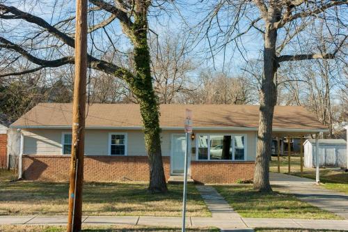 a house with a street sign in front of it at Perfect for family visits to Washington DC or UMD! in College Park