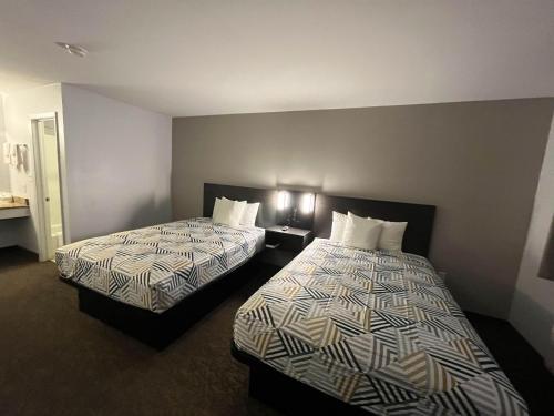 a hotel room with two beds in a room at Motel 6 Junction, TX Llano River in Junction