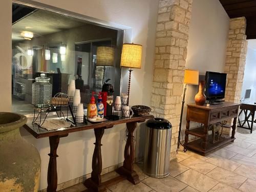 a room with a table with a lamp and a mirror at Motel 6 Junction, TX Llano River in Junction