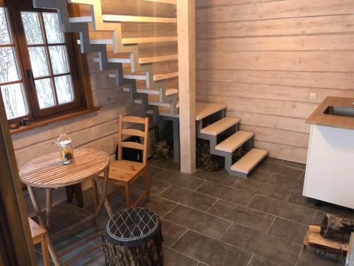 a staircase in a room with a table and a table and a table at Liepų pirtis in Miežoniai