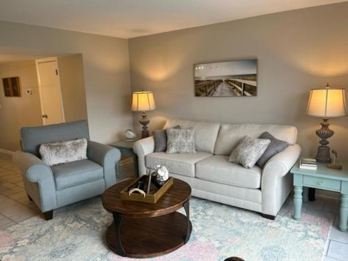 a living room with a couch and two chairs at NEW LISTING! Centrally Located with Pool and Beach Views in Harbor Island