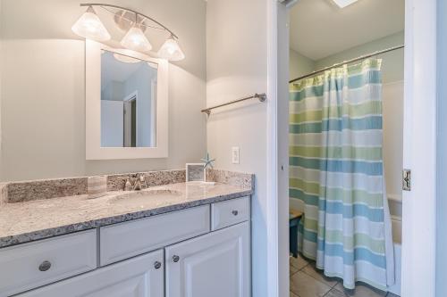 a bathroom with a sink and a shower at New Listing - Overlooking the Pool with Beach Views in Harbor Island