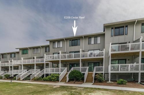 an exterior view of an apartment building with white balconies at New Listing - Overlooking the Pool with Beach Views in Harbor Island