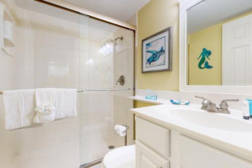 a bathroom with a shower and a sink and a toilet at Island Echoes 5L in Fort Walton Beach