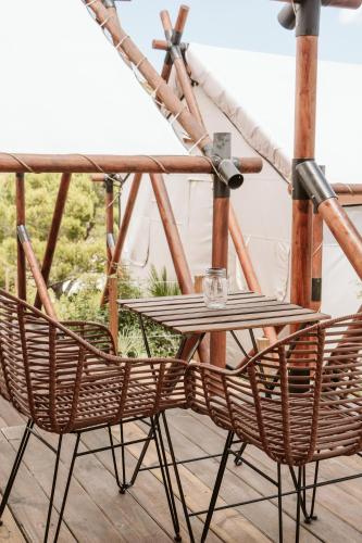 a wooden table and two chairs on a porch at Dreamsea Mediterranean Camp in Benitachell
