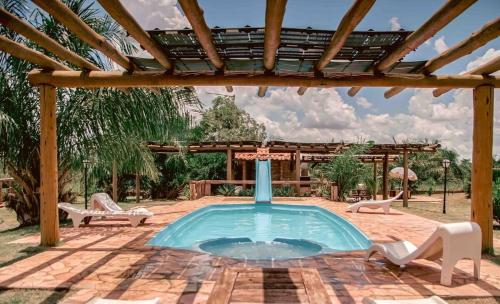 a swimming pool in a patio with a pergola at Paradise Bonito: mansão com piscina in Bonito