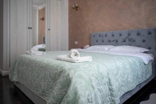 a bedroom with a large bed with towels on it at Pretty House Apartment in Gura Humorului