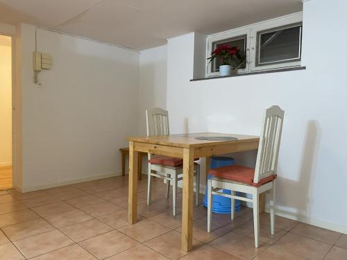 a dining room with a wooden table and chairs at Villa Room in Malmö