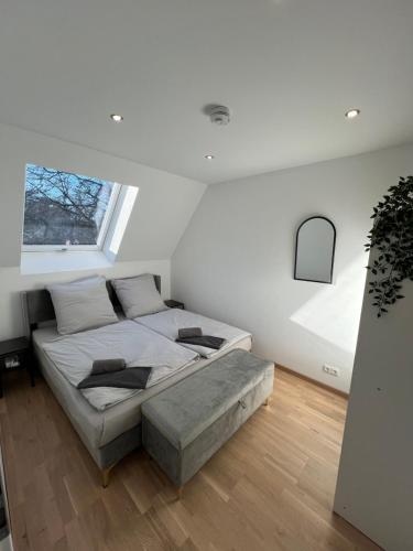 a bedroom with a bed and a large window at Moderne Wohnung Karlsruhe Neureut in Karlsruhe