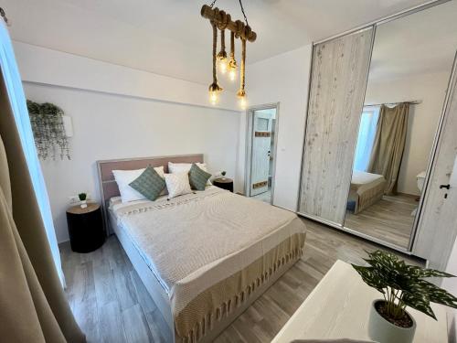 a bedroom with a bed and a large mirror at Aleria Central Apartment 2 in Naxos Chora